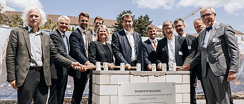 Grundsteinlegung des Helmholtz-Instituts Würzburg. Von links: Prof. Josef Penninger (HZI), Prof. Dirk Heinz (HZI), Dr. Renke Deckarm (EU-Kommission), Christian Scherf (HZI, im Hintergrund), Staatssekretärin Judith Pirscher (BMBF), Ministerpräsident Dr. Markus Söder (Freistaat Bayern), Prof. Jörg Vogel (HIRI), Dipl.-Ing. Rainer Post (doranth post architekten, im Hintergrund), Prof. Otmar D. Wiestler (Helmholtz-Gemeinschaft), Oberbürgermeister Christian Schuchardt (Würzburg), Staatssekretär Roland Weigert (StMWi), Prof. Matthias Frosch (JMU). 